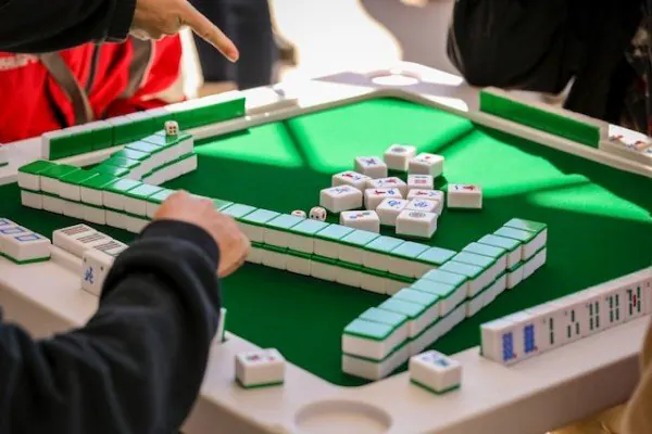 A picture of people playing Mahjong
